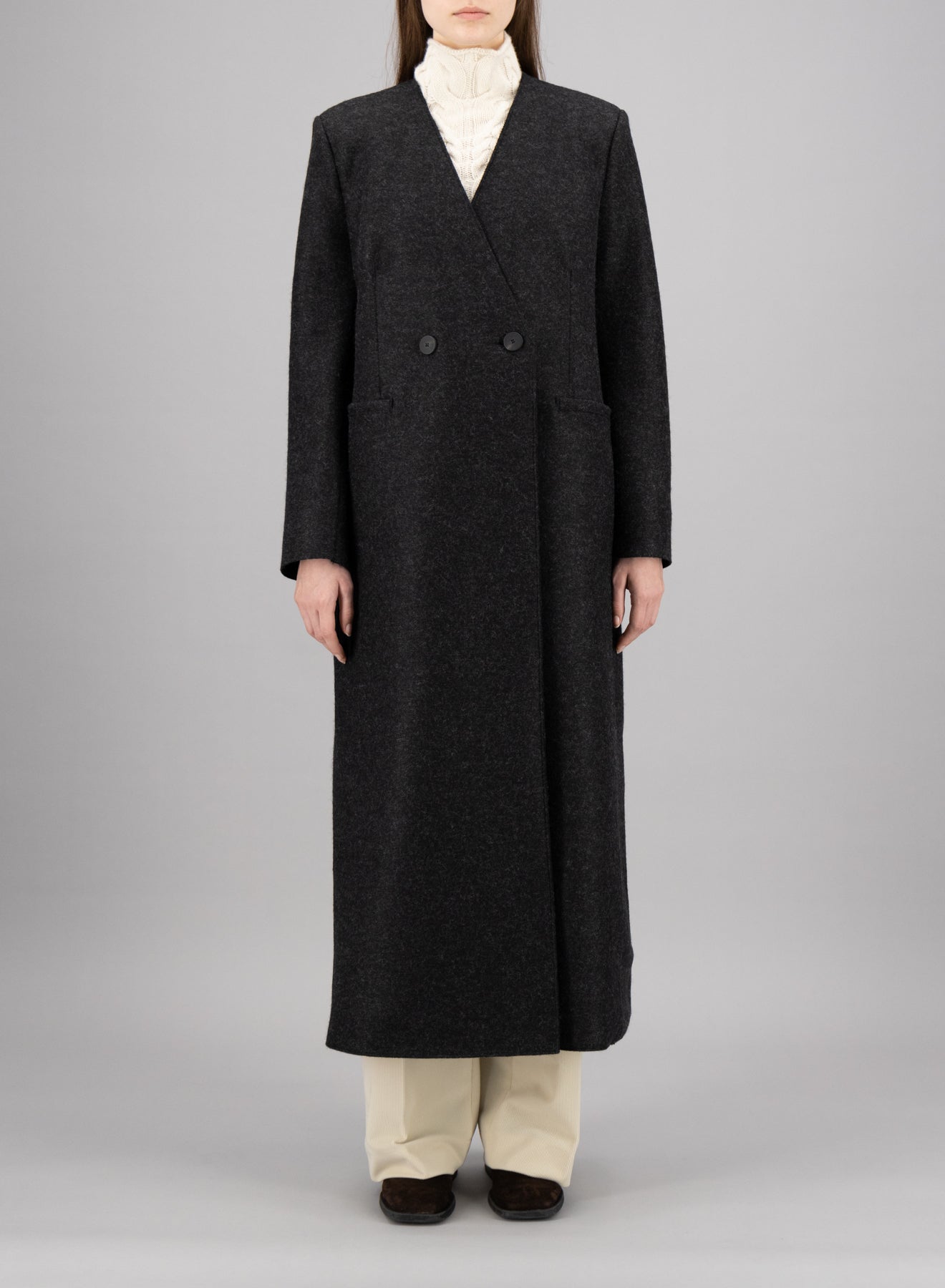 Uncollared coat with shoulder pads pressed wool